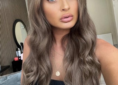 Model with styled waves at Gemini Hair, Birmingham, England, GB showcasing salon's elegant interior.
