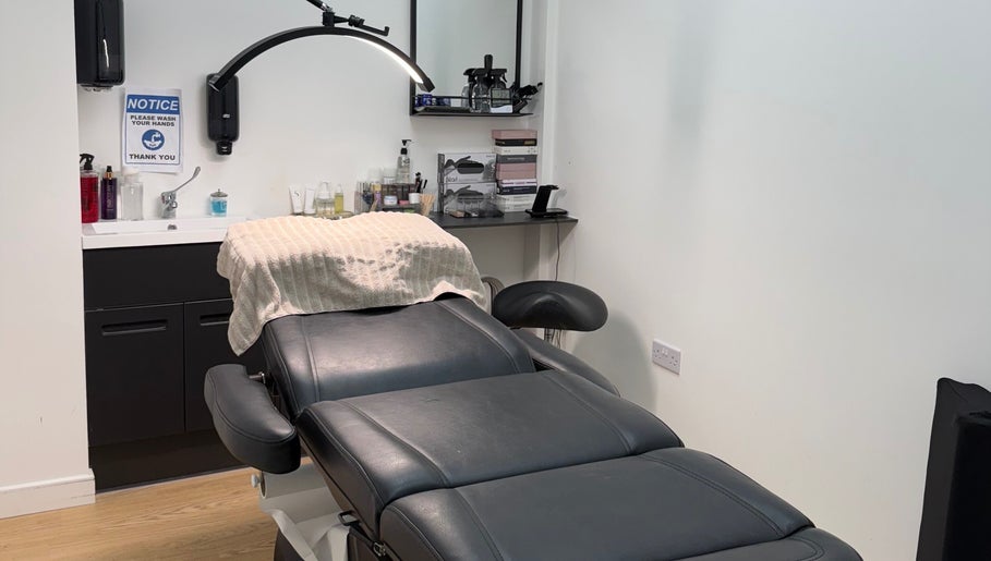 Elegant treatment room at Simone Services, Edinburgh, Scotland, GB featuring a plush black chair and modern amenities.