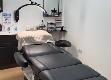 Elegant treatment room at Simone Services, Edinburgh, Scotland, GB featuring a plush black chair and modern amenities.