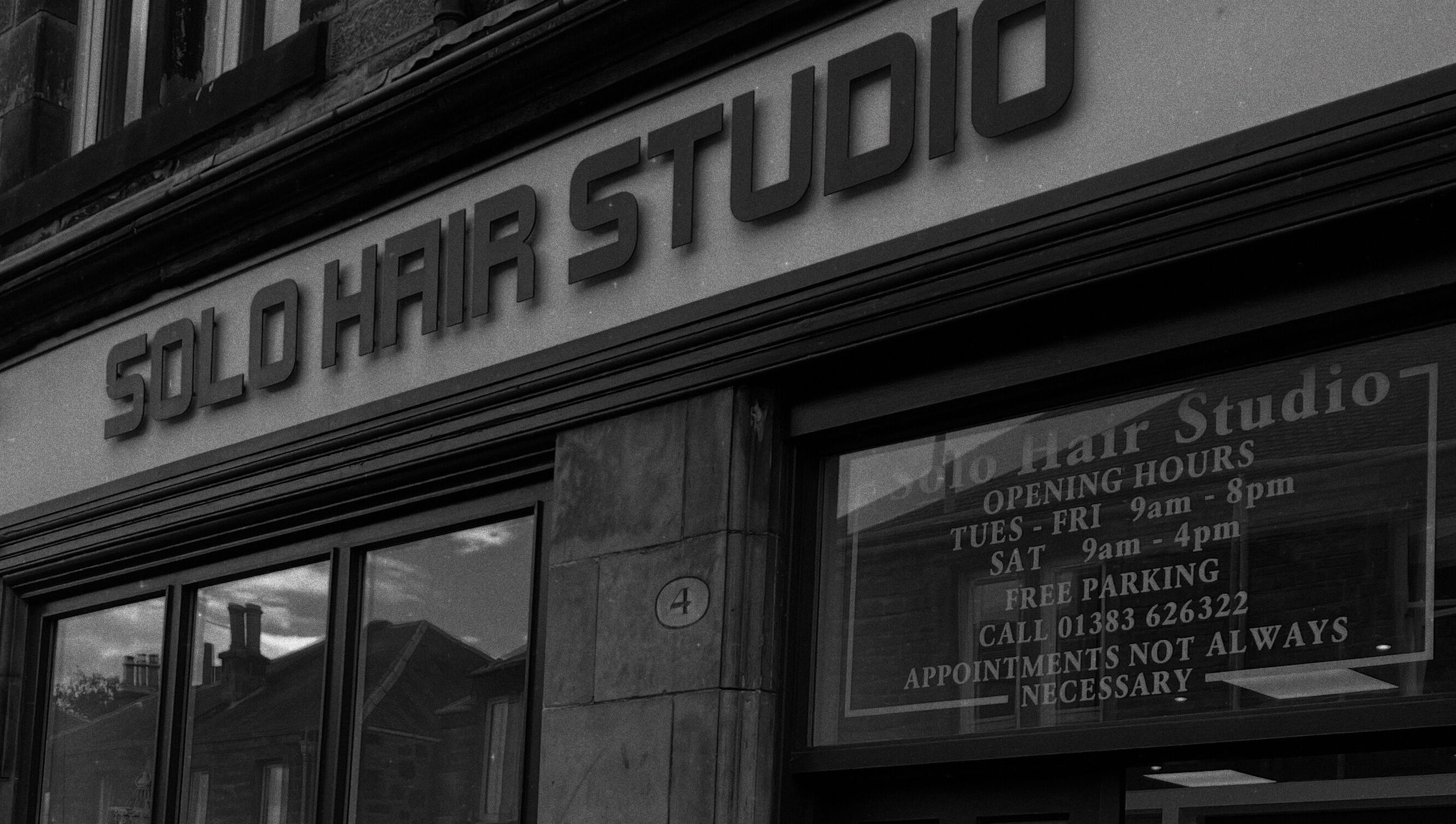 Entrance of Hair By Kody McCallum in Dunfermline, Scotland, GB featuring sleek salon signage.