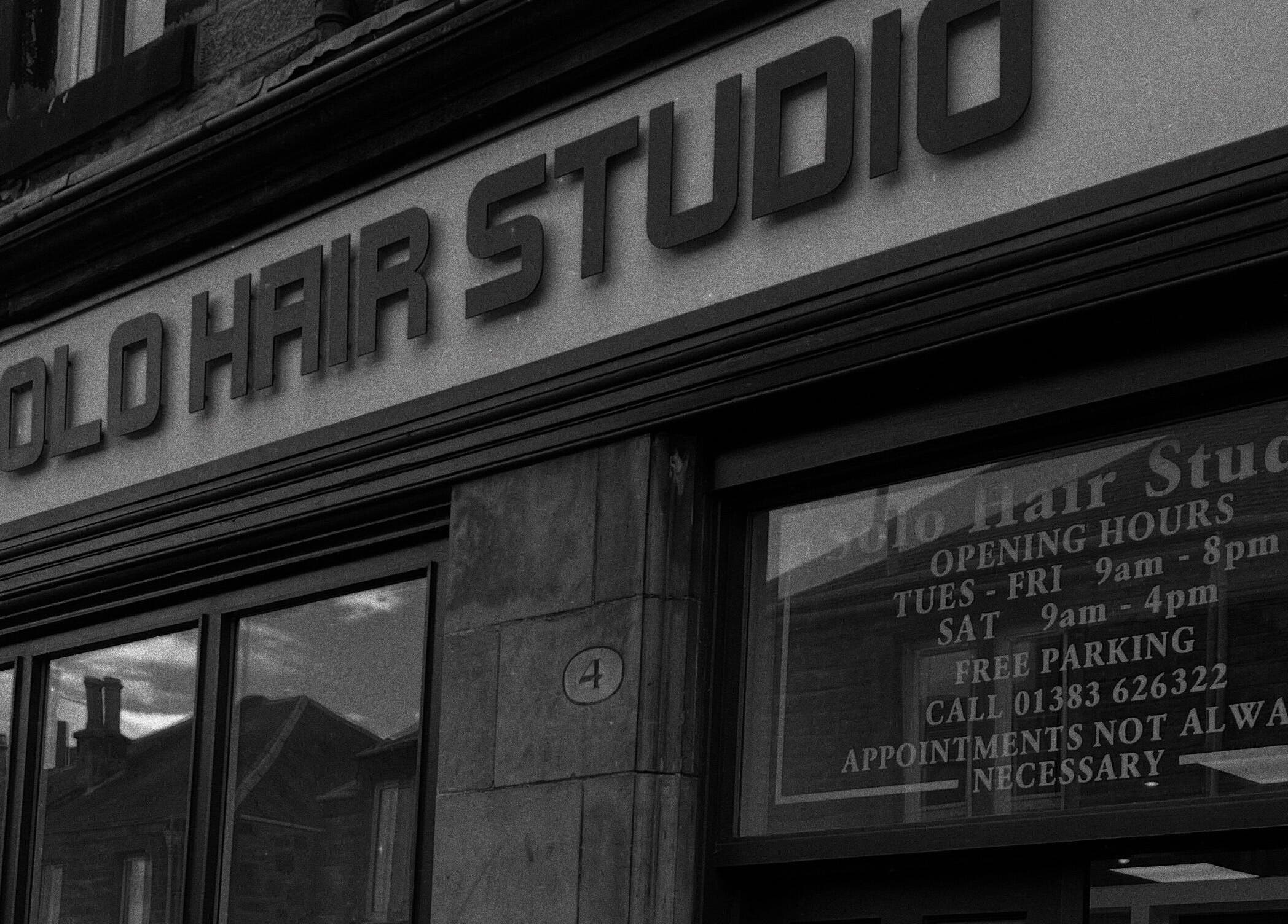 Entrance of Hair By Kody McCallum in Dunfermline, Scotland, GB featuring sleek salon signage.