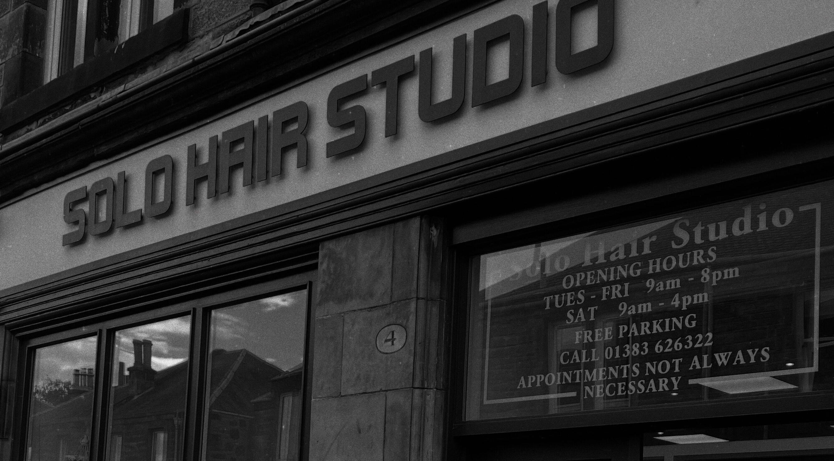 Entrance of Hair By Kody McCallum in Dunfermline, Scotland, GB featuring sleek salon signage.