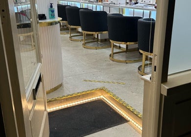 View into Sunrise Hand & Foot Spa, Bray, with chic seating and glowing entry lights.