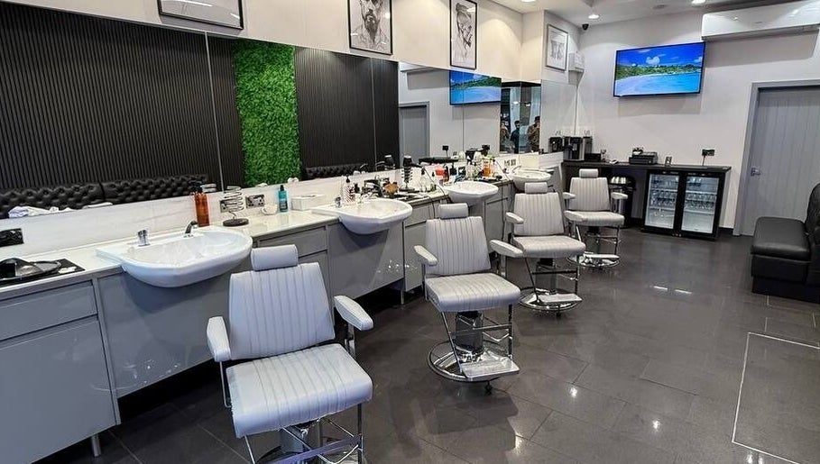 Spacious interior of Db Barbers Tooting Bec, London, England, GB with modern barber chairs and stylish decor.