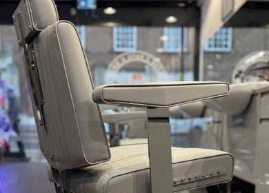 Elegant barber chair at Db Barbers Tooting Bec, London, England, GB, showcasing modern style and comfort.