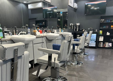 Modern barber chairs in sleek interior at Db Barbers Tooting Bec, London, England, GB.