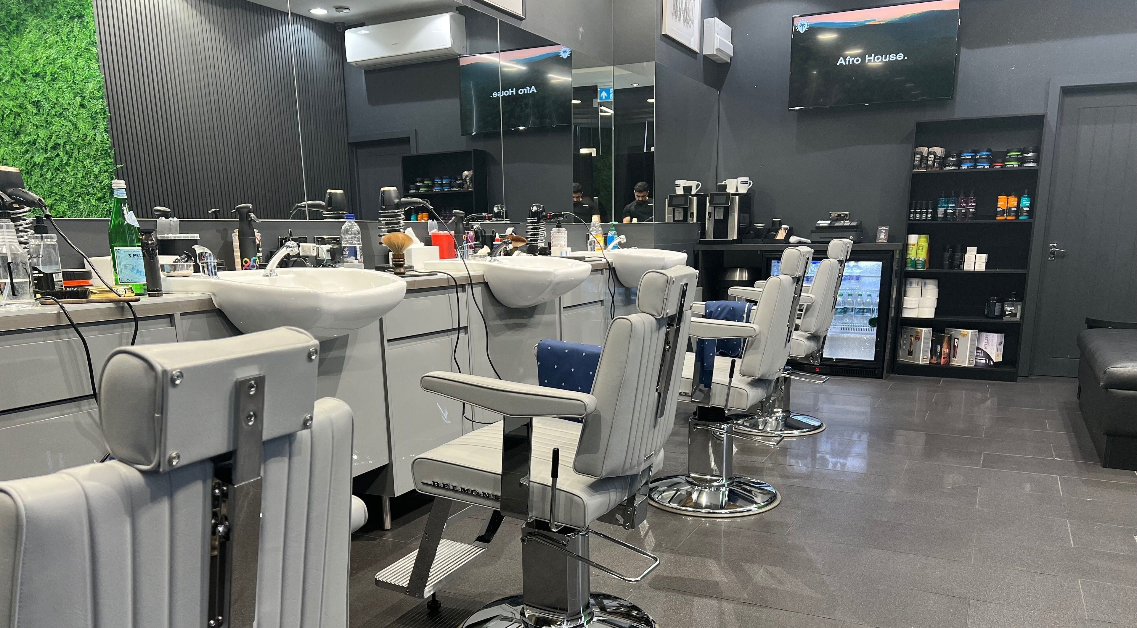 Modern barber chairs in sleek interior at Db Barbers Tooting Bec, London, England, GB.
