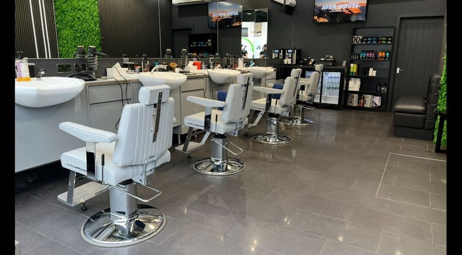 Modern barber chairs at Db Barbers Tooting Bec, London, England, GB showcasing sleek interior design.