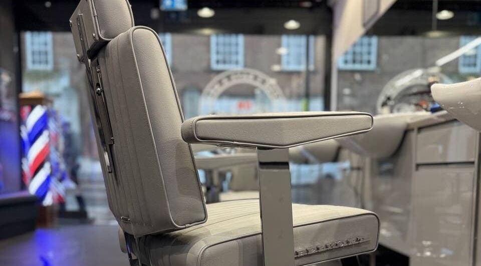 Classic barber chair at Db Barbers Tooting Bec, London, England, GB reflects traditional style.