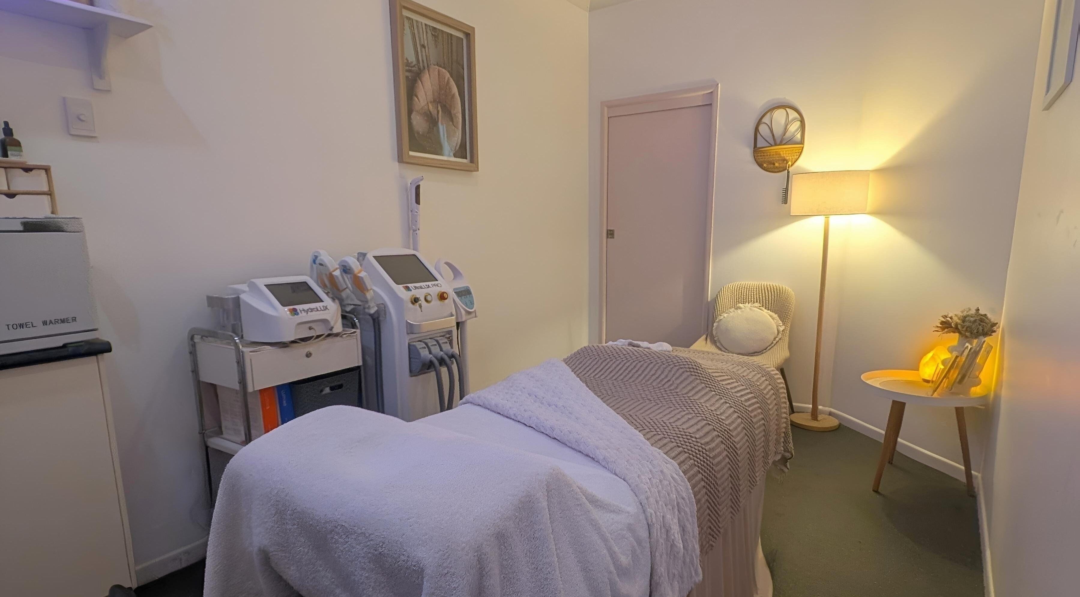 Cozy treatment room at Effekt Skin Clinic, Berserker, Queensland, AU with equipment and warm lighting.