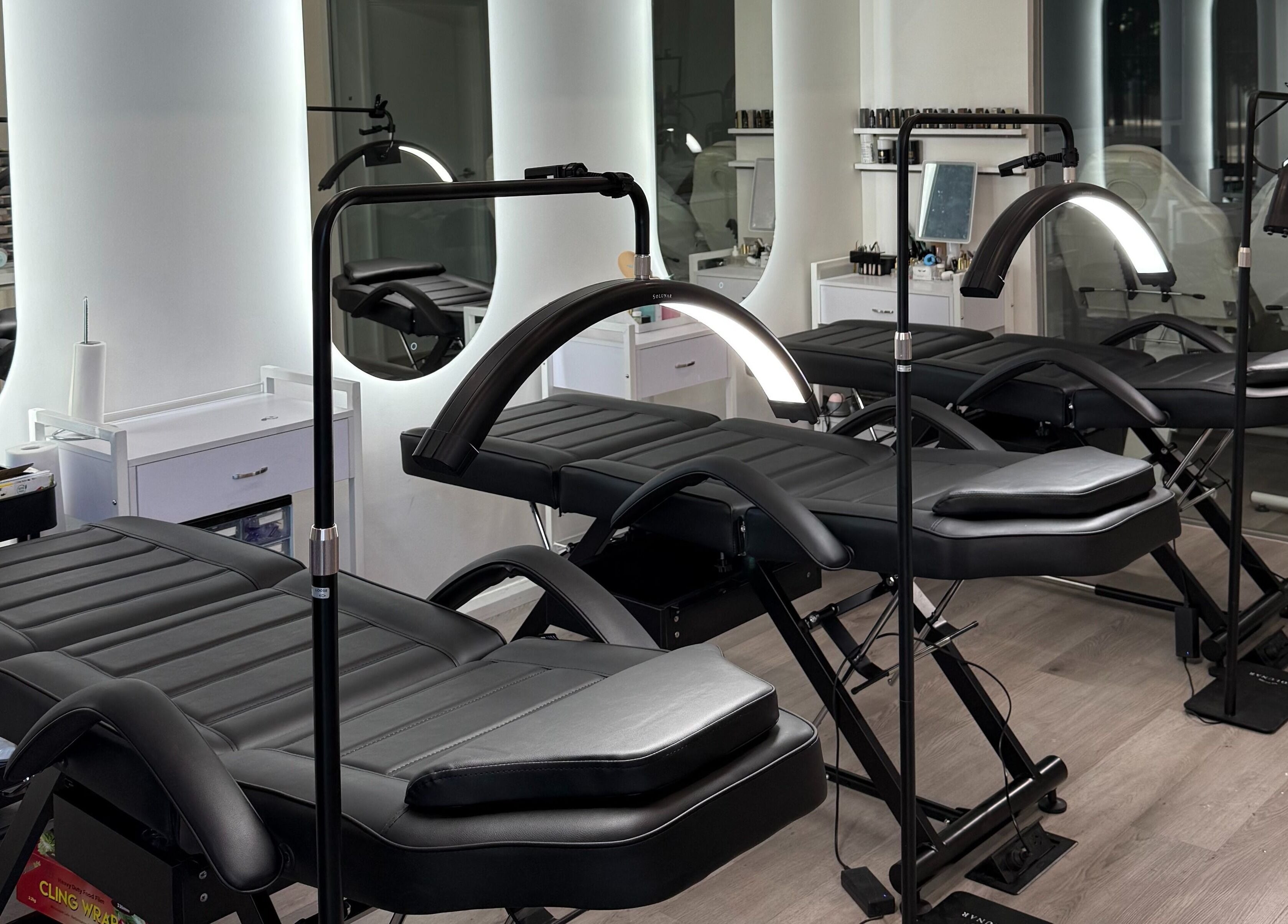 Modern treatment beds at Allure Artistry & Co, Melbourne, Victoria, AU ready for beauty sessions.