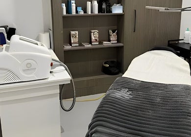 Calming treatment room at Allure Artistry & Co in Melbourne, Victoria, AU with a spa bed and professional equipment.