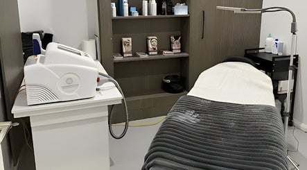 Calming treatment room at Allure Artistry & Co in Melbourne, Victoria, AU with a spa bed and professional equipment.