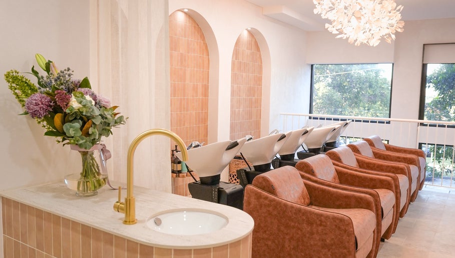 Elegant wash area at Lady K Hair Artistry in Bronte, New South Wales, AU, featuring modern decor and stylish chairs.