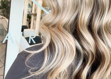 Blonde wavy hair styled at Lady K Hair Artistry, Bronte, New South Wales, AU, reflecting expert care and artistry.