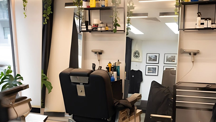 Modern interior of Kiru Barbershop in Surry Hills, New South Wales, AU, showcasing a stylish barber chair and sleek decor.