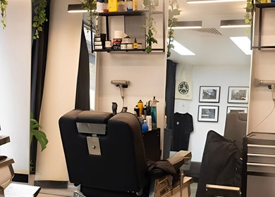 Modern interior of Kiru Barbershop in Surry Hills, New South Wales, AU, showcasing a stylish barber chair and sleek decor.