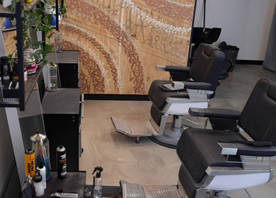Chic interior of Kiru Barbershop, Surry Hills, New South Wales, AU with sleek barber chairs and styling products.