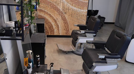 Chic interior of Kiru Barbershop, Surry Hills, New South Wales, AU with sleek barber chairs and styling products.