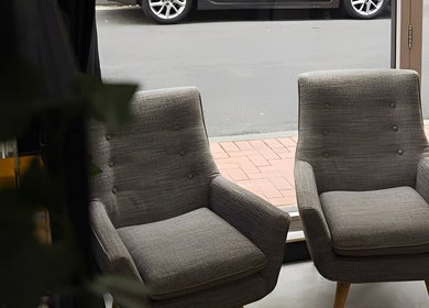 Comfortable gray chairs in Kiru Barbershop, Surry Hills, New South Wales, AU, creating a welcoming atmosphere.