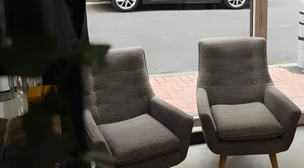 Comfortable gray chairs in Kiru Barbershop, Surry Hills, New South Wales, AU, creating a welcoming atmosphere.