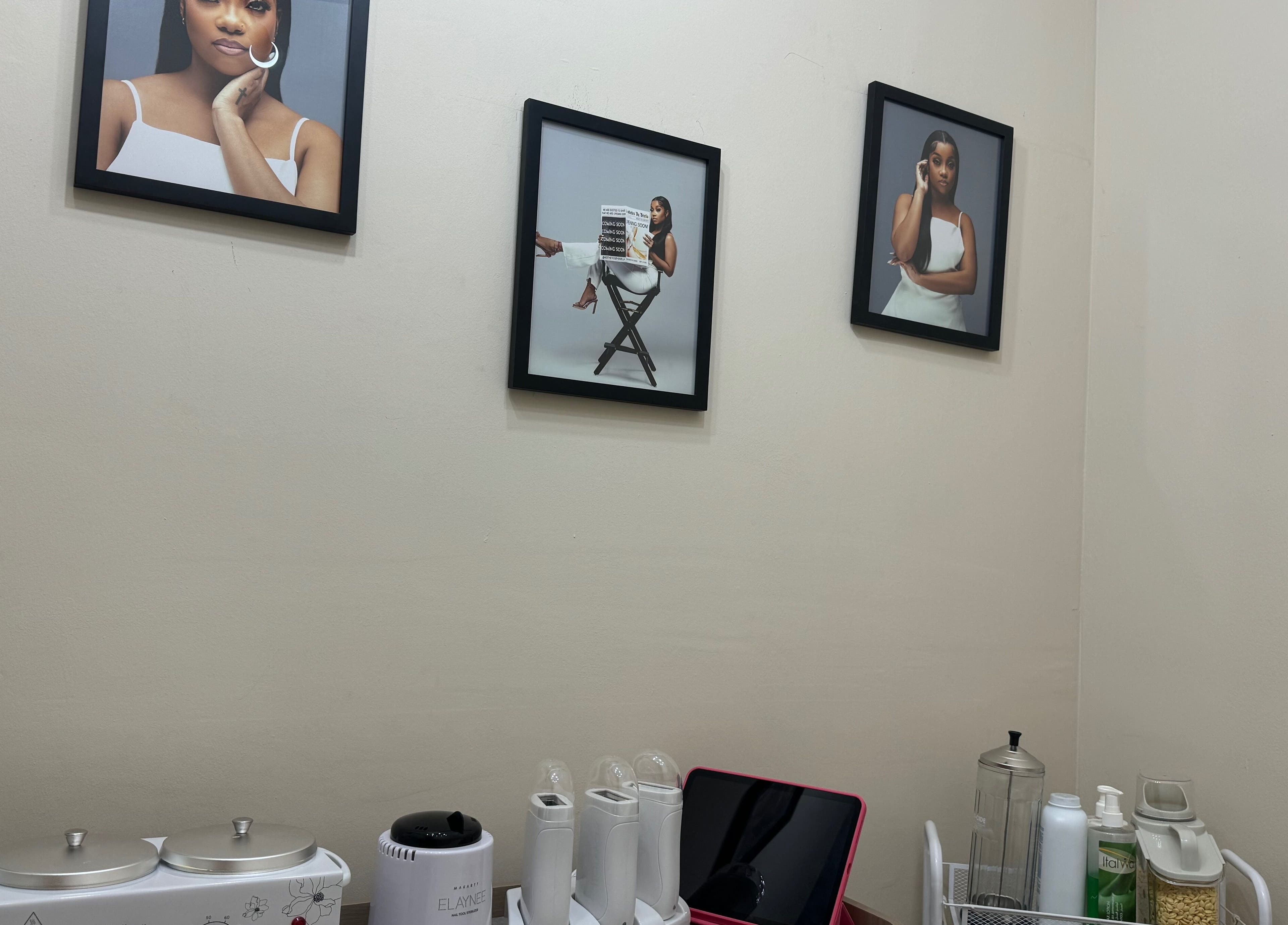 Modern wall decor at Aesthetics by Briella in Montego Bay, St. James Parish, JM, features stylish art and skincare tools.