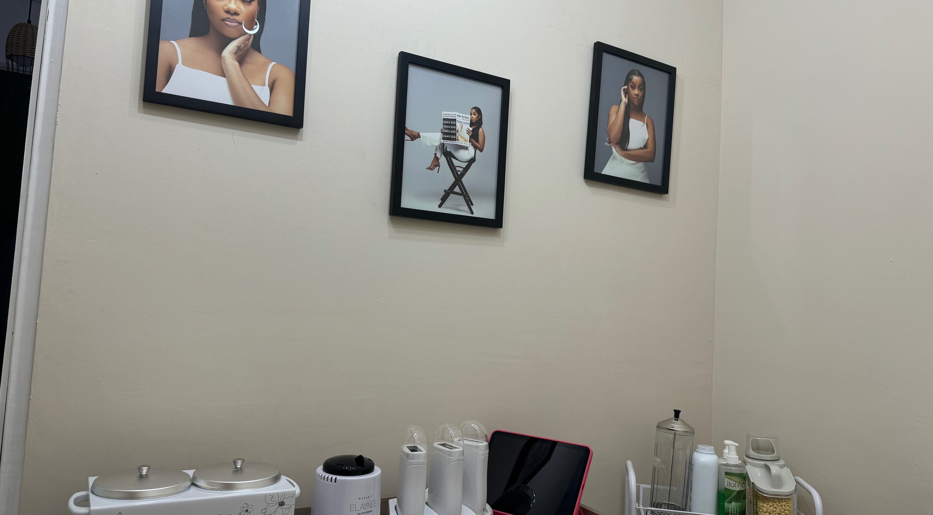Modern wall decor at Aesthetics by Briella in Montego Bay, St. James Parish, JM, features stylish art and skincare tools.