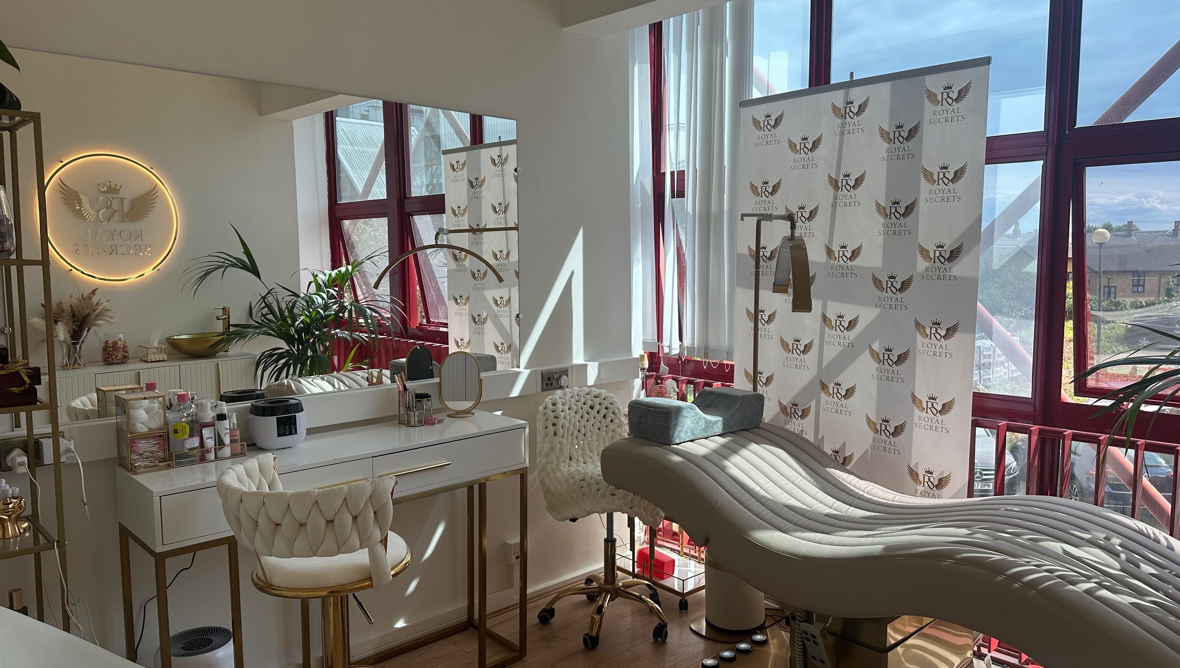 Luxurious beauty salon Royal Secrets in London, England, GB with plush chairs and modern decor.