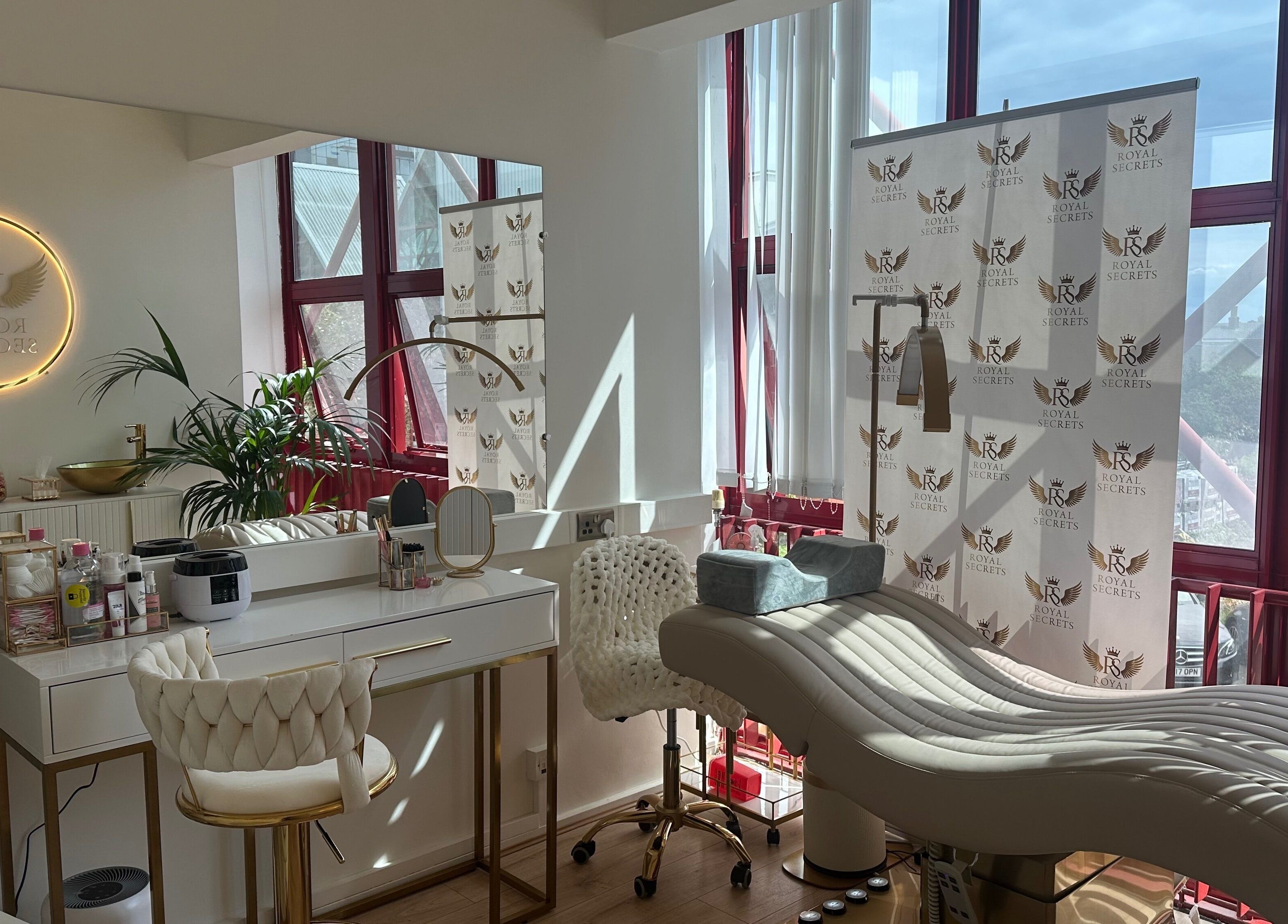 Luxurious beauty salon Royal Secrets in London, England, GB with plush chairs and modern decor.