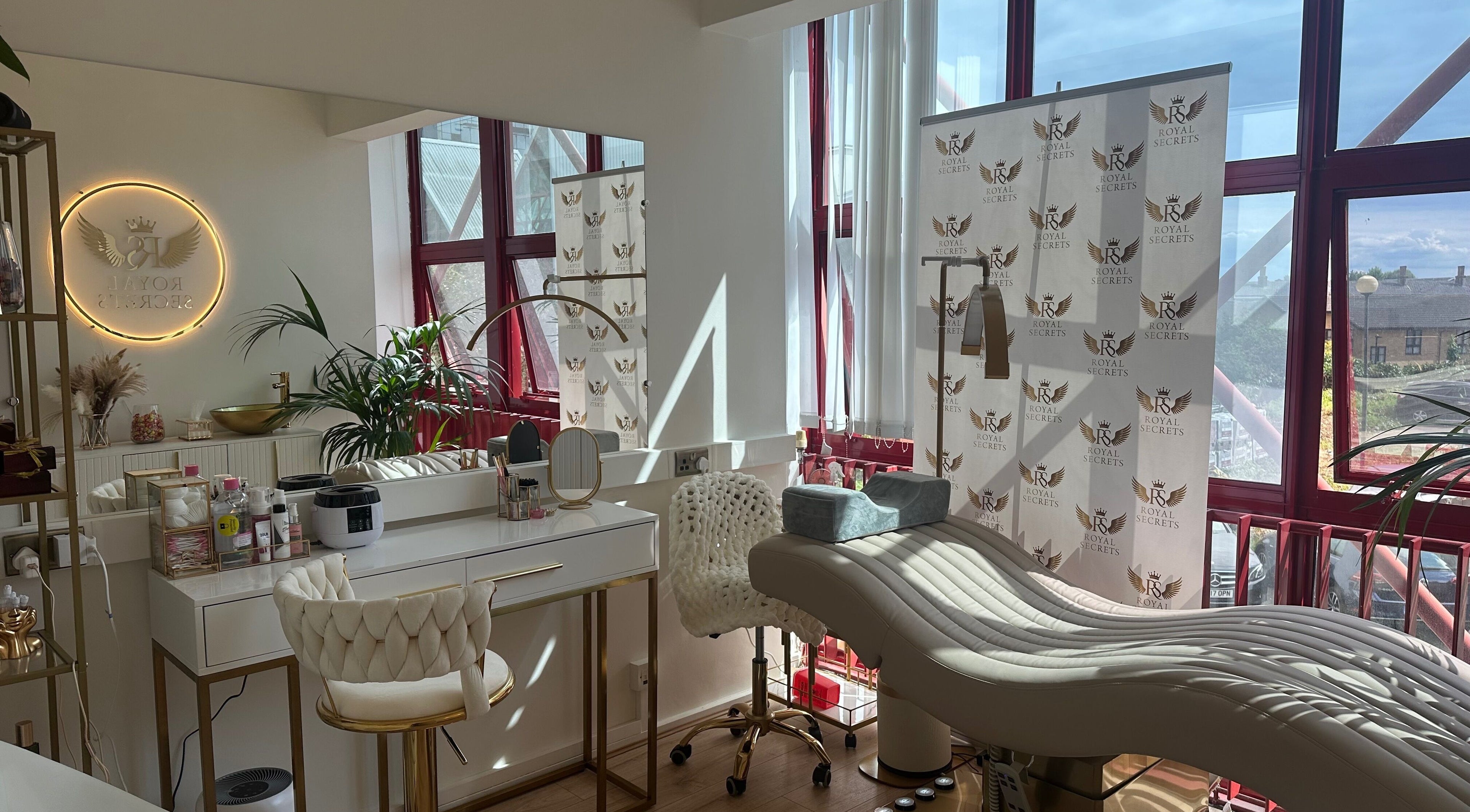 Luxurious beauty salon Royal Secrets in London, England, GB with plush chairs and modern decor.