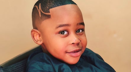 Child with a trendy haircut at Favour Barbershop in Thembisa, Gauteng, ZA, showcasing style and precision.