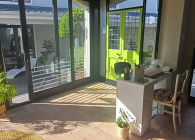 Bright, welcoming entrance at Nails by Shannon, Gqeberha, Eastern Cape, ZA with lush plants and modern decor.