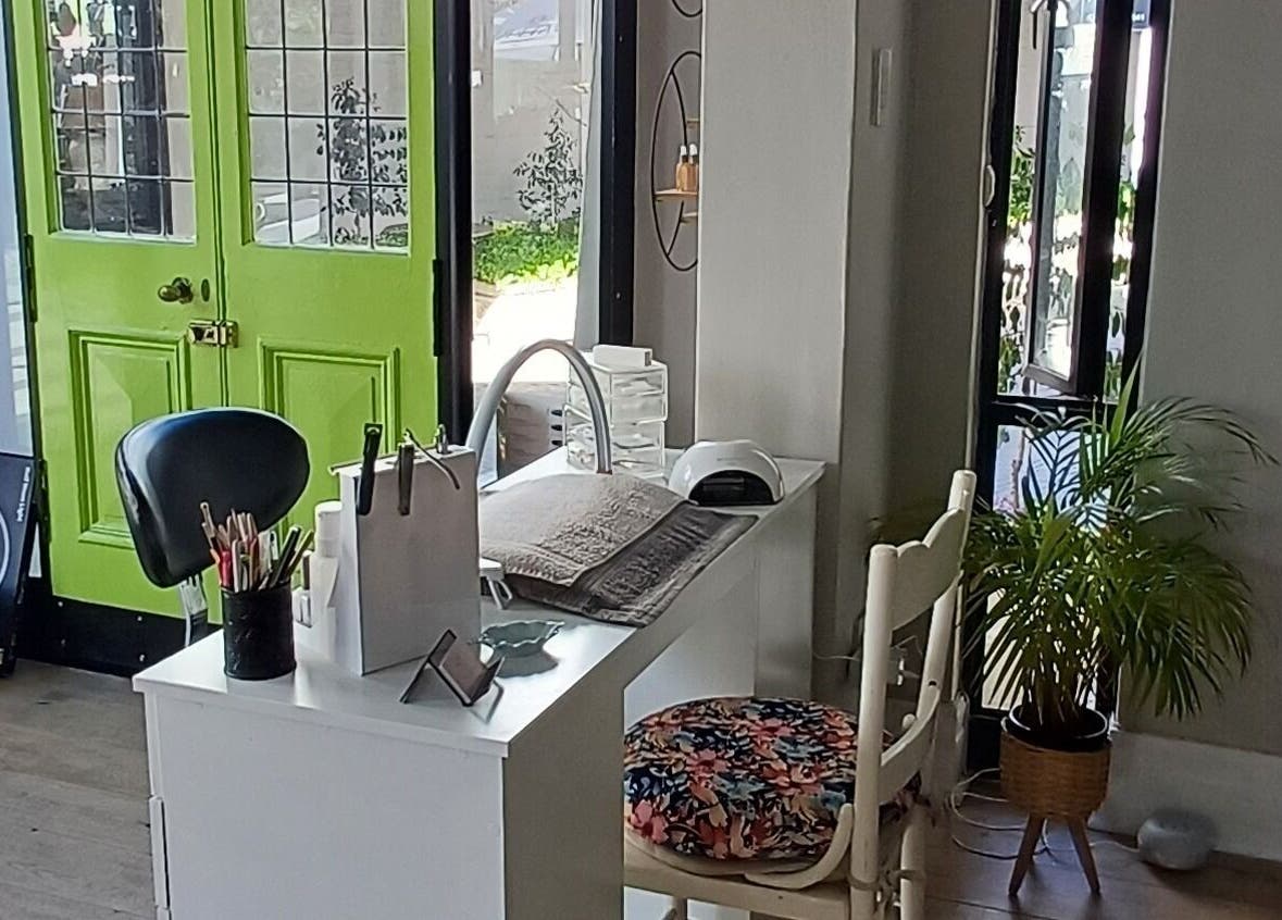 Modern nail studio interior at Nails by Shannon in Gqeberha, Eastern Cape, ZA with a vibrant green door.