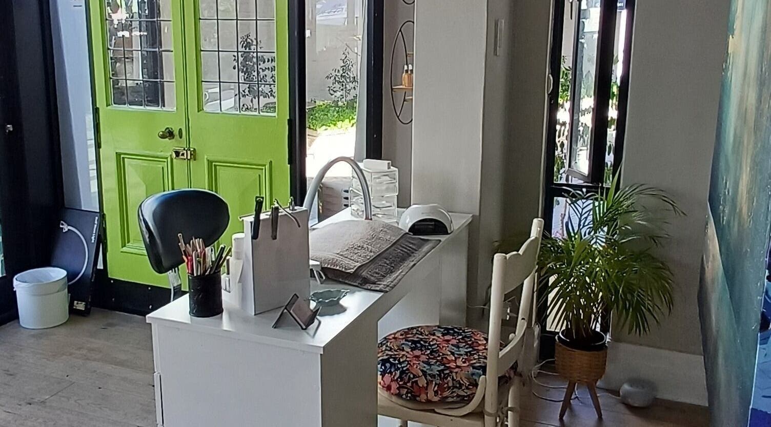 Modern nail studio interior at Nails by Shannon in Gqeberha, Eastern Cape, ZA with a vibrant green door.