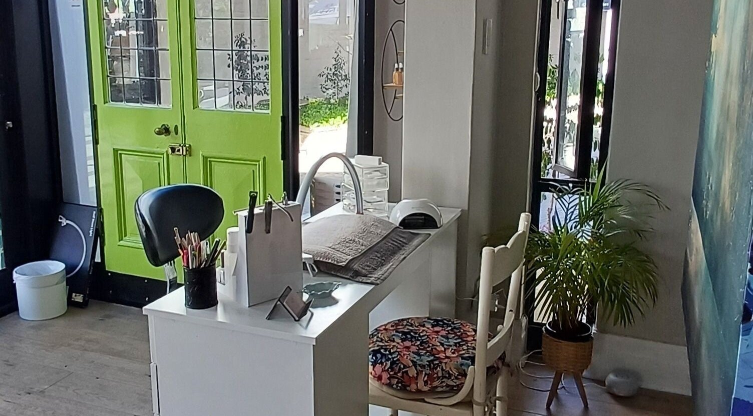 Modern nail studio interior at Nails by Shannon in Gqeberha, Eastern Cape, ZA with a vibrant green door.