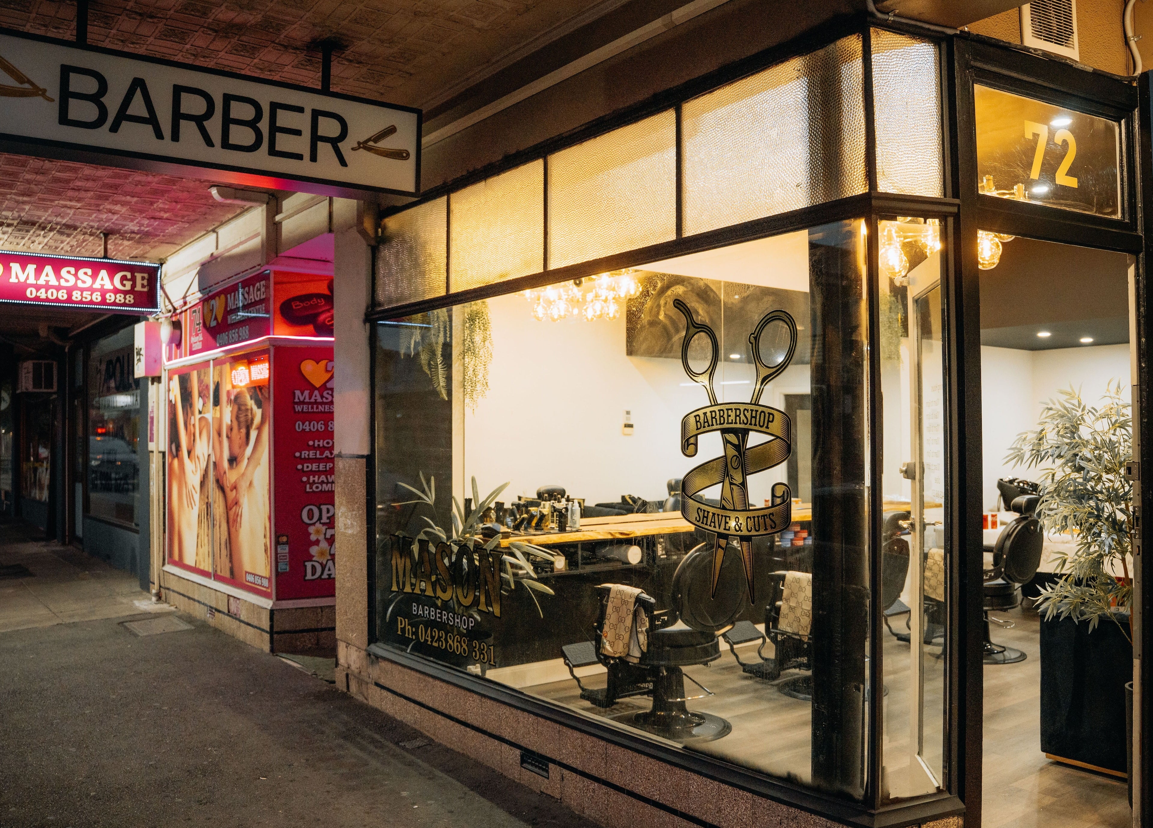 Exterior of Mason Barbershop, a stylish barber venue in Melbourne, Victoria, AU, showing inviting nighttime ambiance.