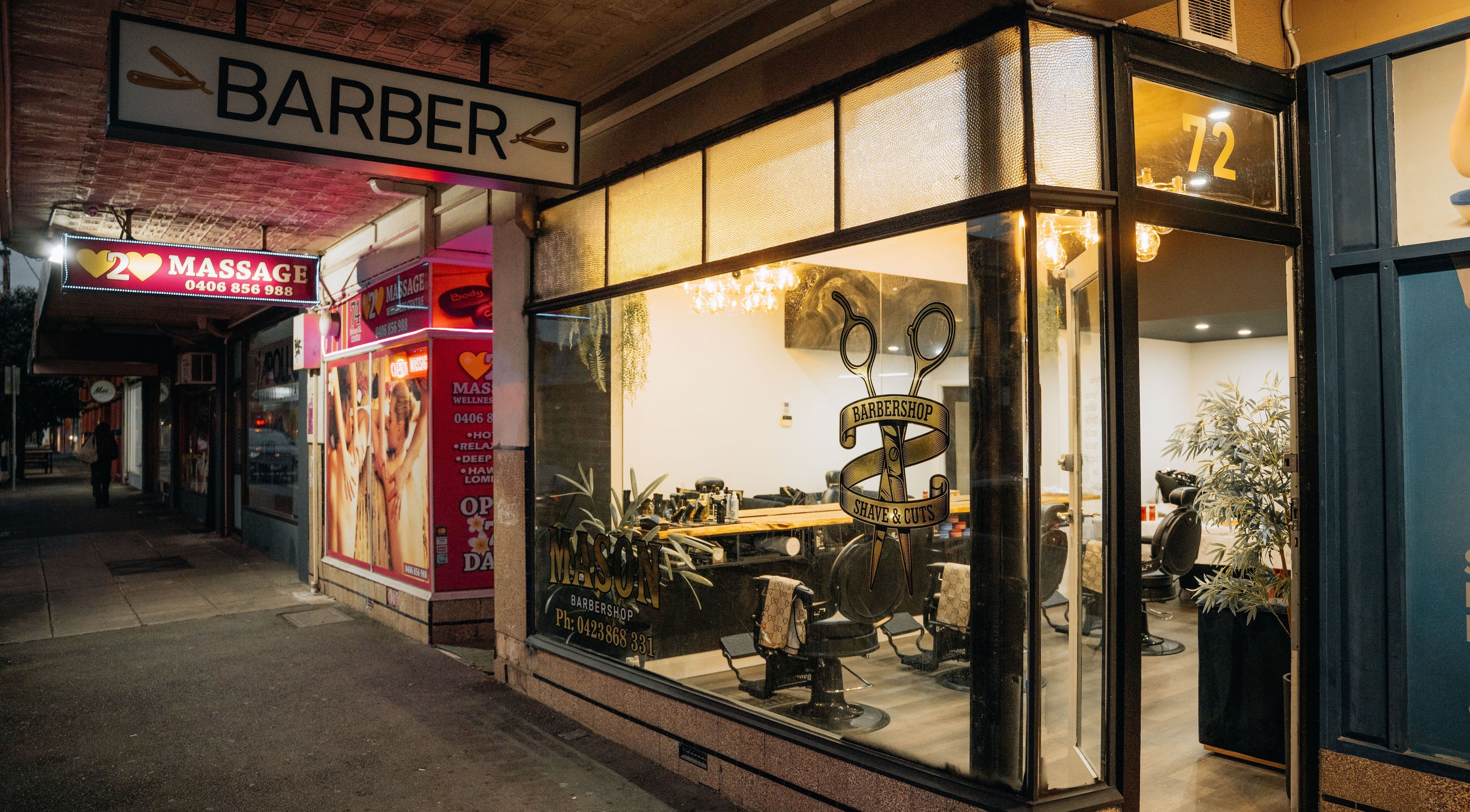 Exterior of Mason Barbershop, a stylish barber venue in Melbourne, Victoria, AU, showing inviting nighttime ambiance.