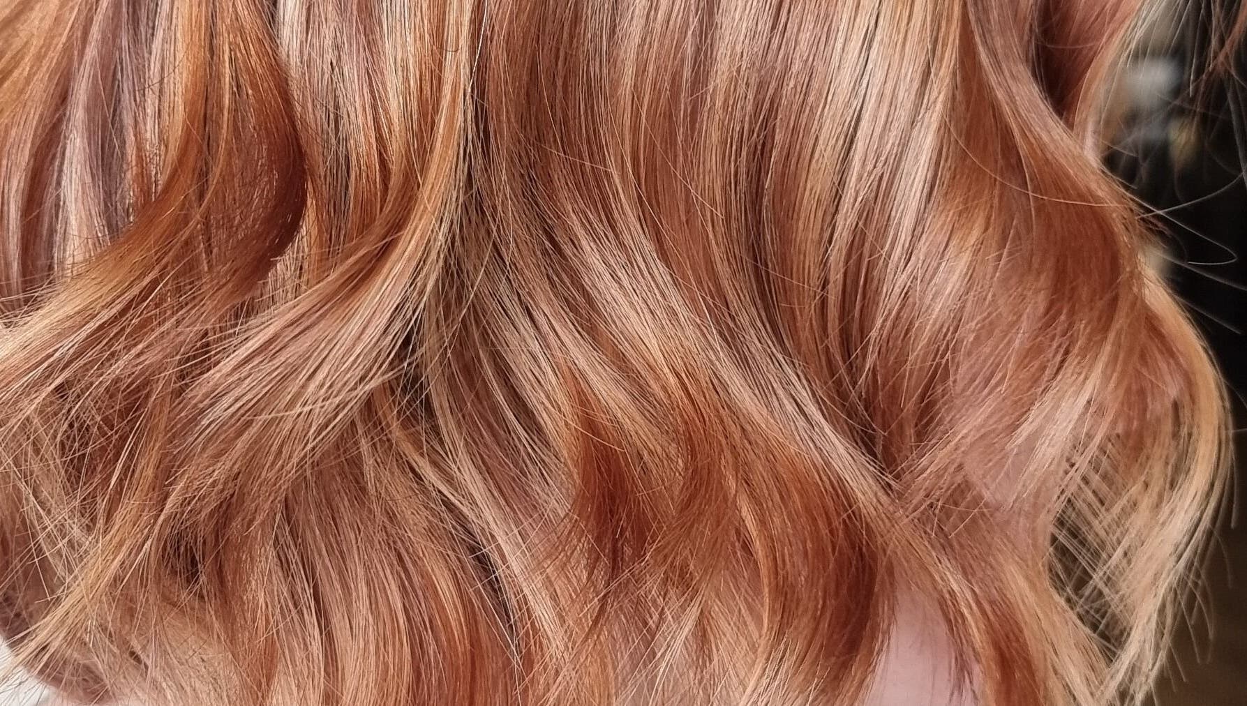 Rich copper hair waves styled at Brushed Salon, Penarth, Wales, GB for vibrant and luxurious hair shine.