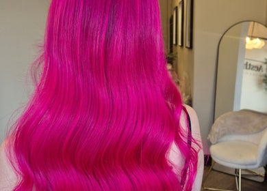 Stunning vivid pink hair styled in waves at Brushed Salon, Penarth, Wales, GB.