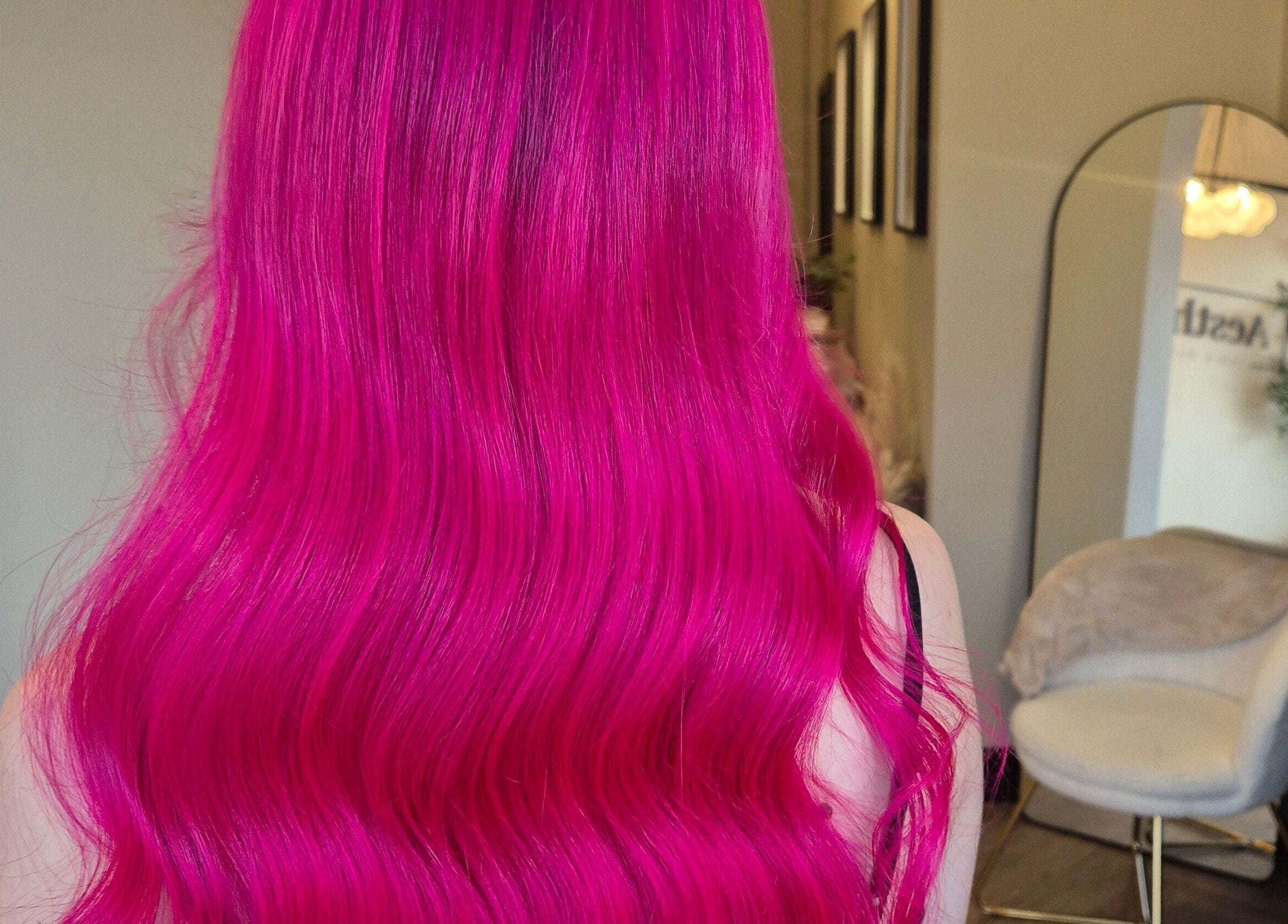 Stunning vivid pink hair styled in waves at Brushed Salon, Penarth, Wales, GB.