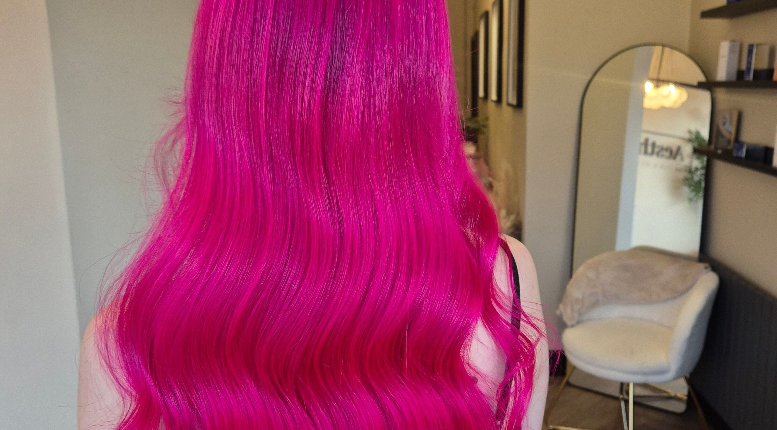 Stunning vivid pink hair styled in waves at Brushed Salon, Penarth, Wales, GB.
