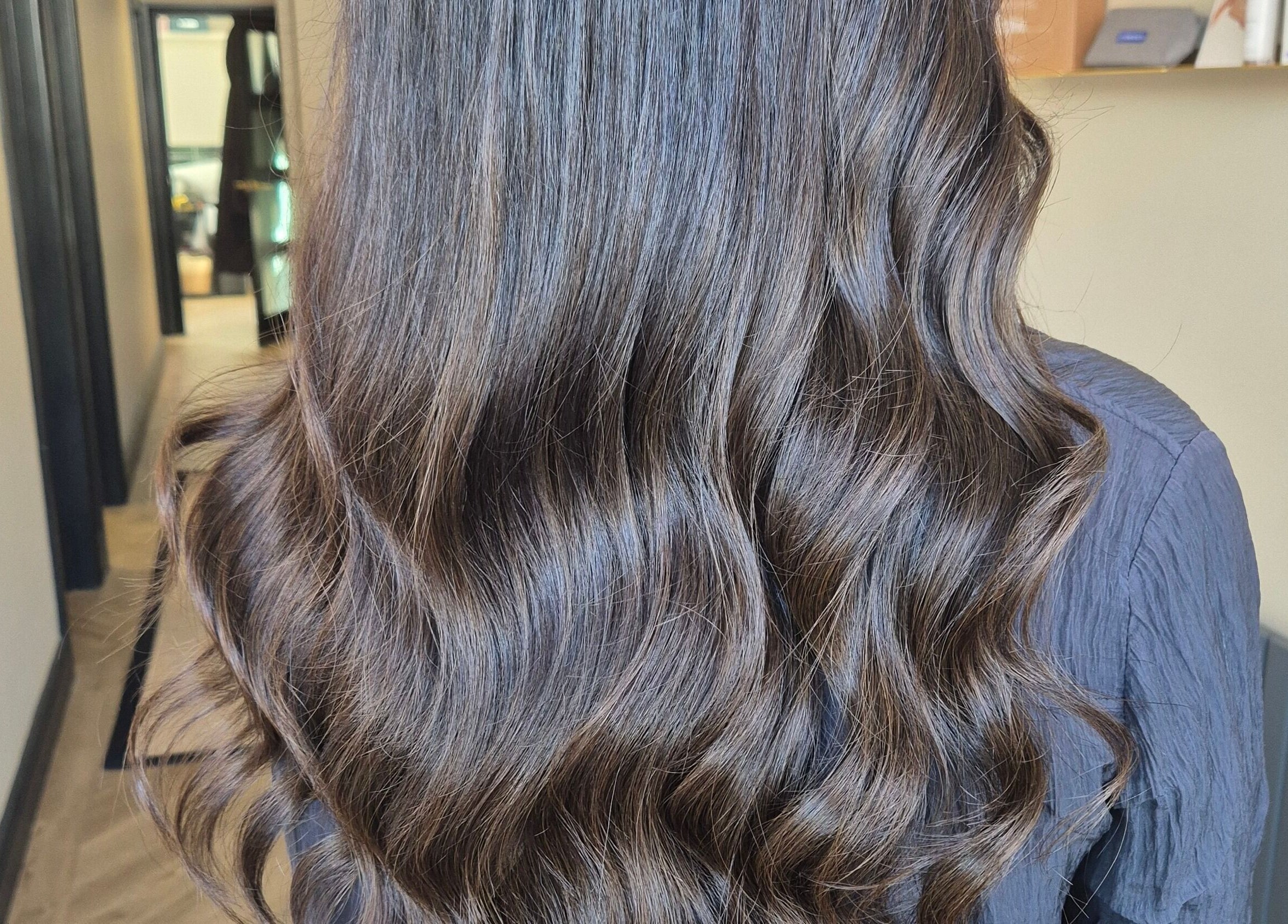 Beautiful wavy hair styling at Brushed Salon, Penarth, Wales, GB. Experience luxury hair care.