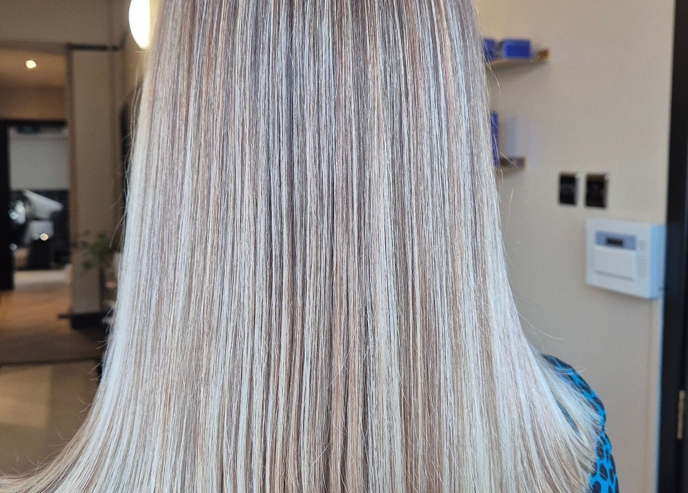 Sleek blonde hair at Brushed Salon, Penarth, Wales, GB, showcasing expert styling and coloring.