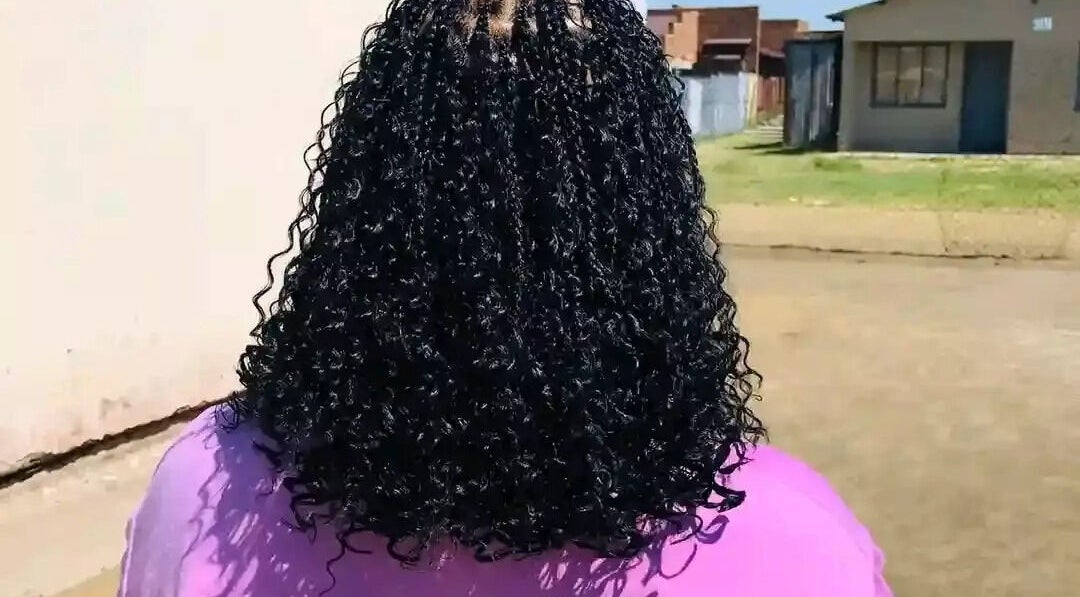 Back view of styled curly hair at Nomsa's beauty salon in Vanderbijlpark, Gauteng, ZA.