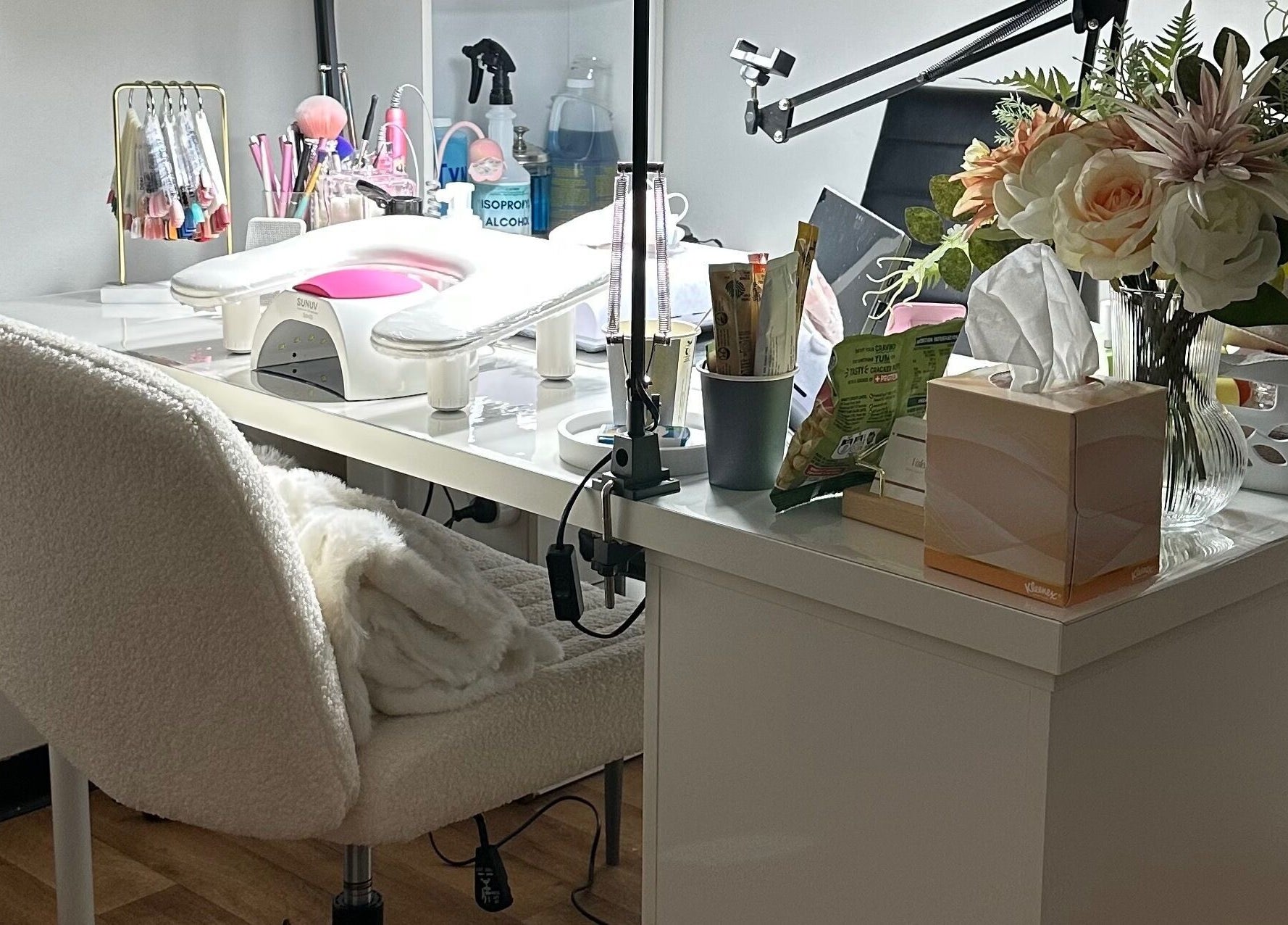 Elegant nail station at Valen Nails, Croydon, South Australia, showcasing tools and floral decor.