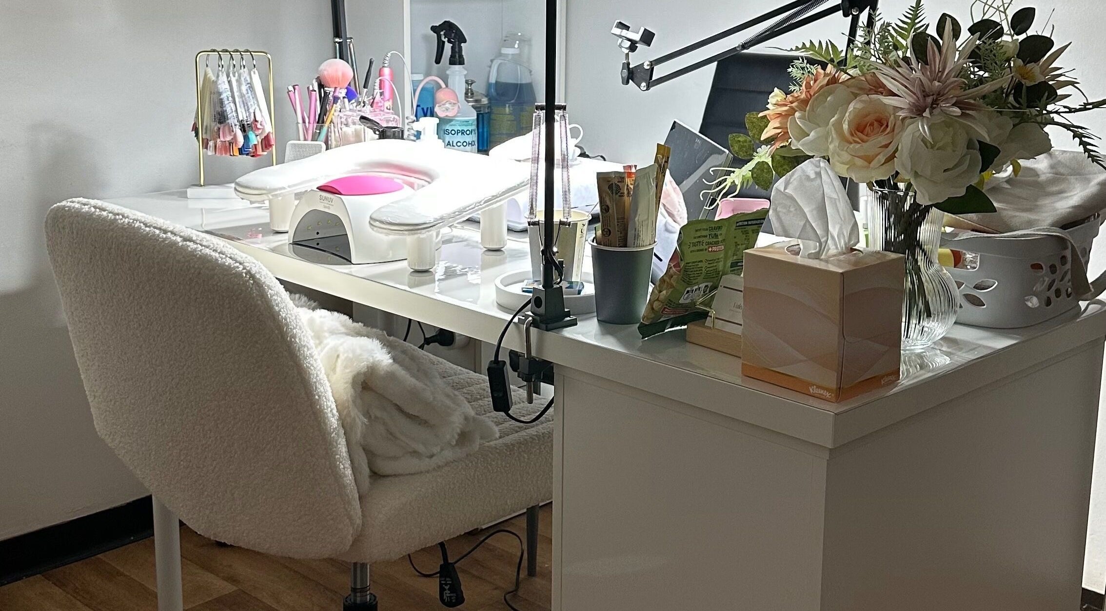 Elegant nail station at Valen Nails, Croydon, South Australia, showcasing tools and floral decor.