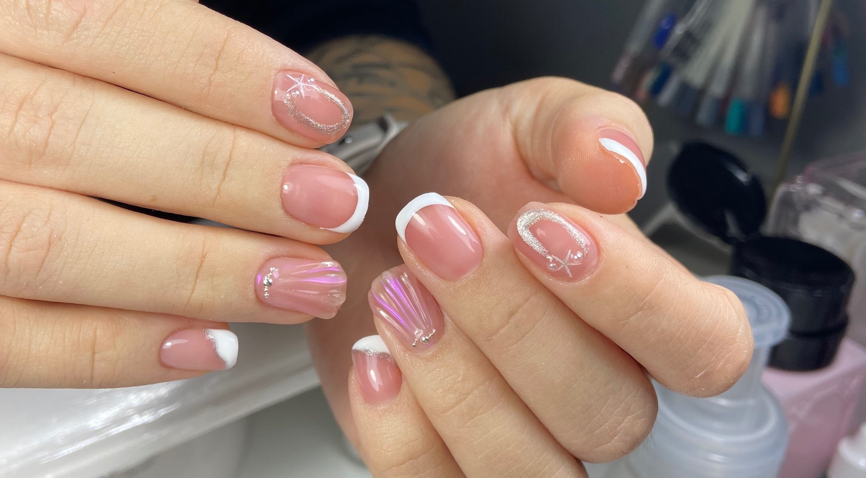 Elegant manicure at Valen Nails, Croydon, South Australia, AU showcasing French tips and sparkling nail art.