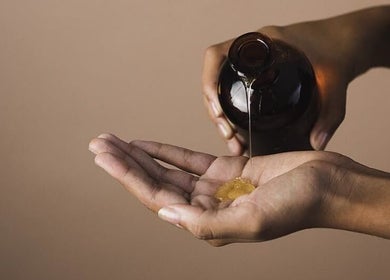Close-up of oil being poured into a hand at Maison Iaso, London, GB, highlighting wellness and relaxation.