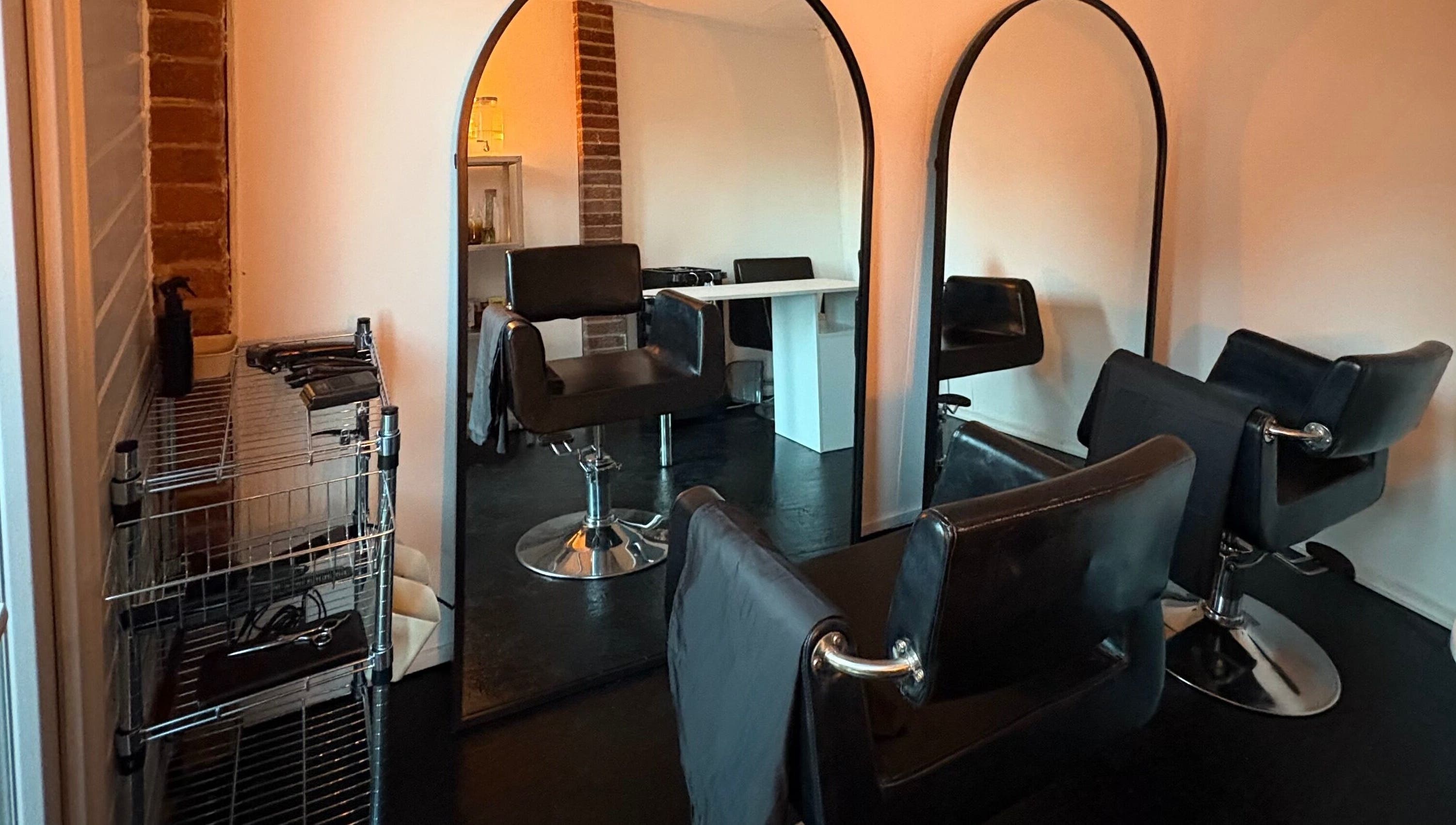 Elegant salon setup at Concept.6, Rainworth, England with modern chairs and mirrors.