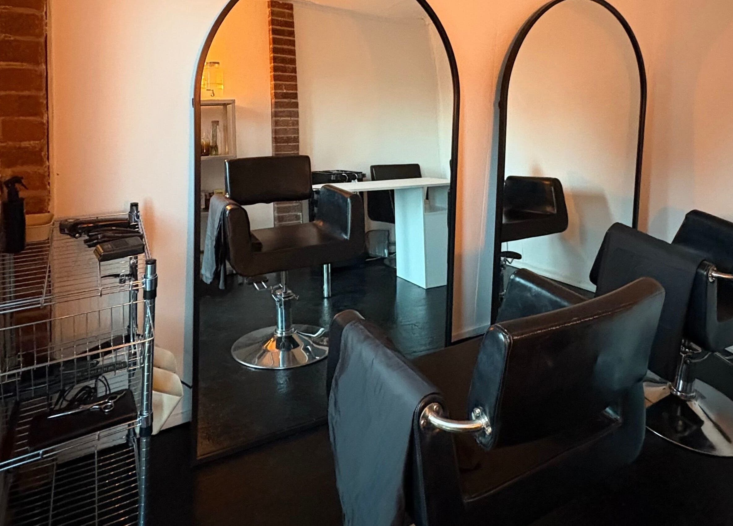 Elegant salon setup at Concept.6, Rainworth, England with modern chairs and mirrors.